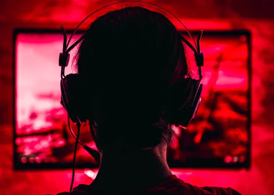 gamer with headphones on red background