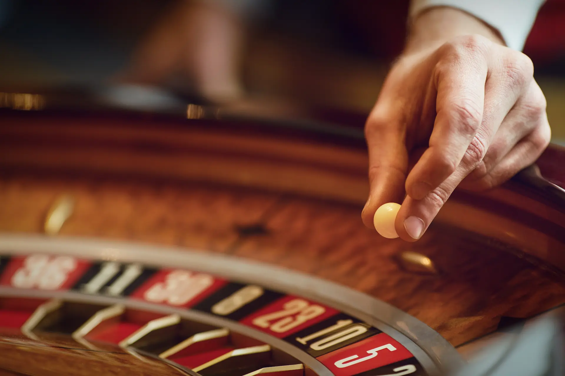 croupier's hand spinning the roulette